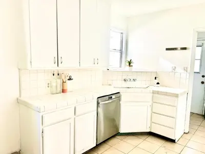 a white kitchen with white cabinets and a dishwasher at Spacious 3BR House Culver City Santa Monica & West LA in Los Angeles
