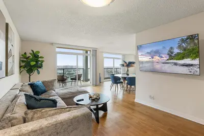a living room with a couch and a table at Golden Hour Glow - Stunning 3BR Overlooking the Marina in Los Angeles