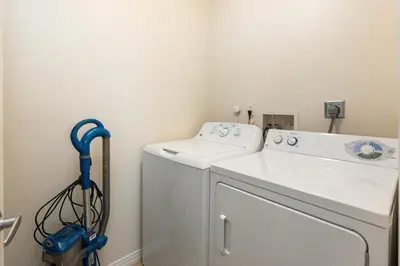 a white washer and dryer in a laundry room at Golden Hour Glow - Stunning 3BR Overlooking the Marina in Los Angeles