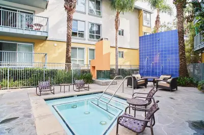 a patio with a pool with chairs and a table at Golden Hour Glow - Stunning 3BR Overlooking the Marina in Los Angeles