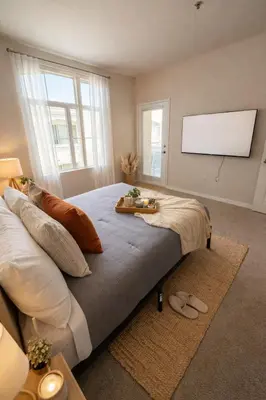 a bedroom with a large bed with a flat screen tv at Marina Del Rey 2BR-2BA & 1 BR-1BA - Easy Trip To Venice Boardwalk in Los Angeles