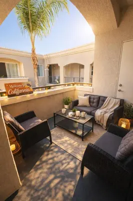 a living room with couches and a palm tree at Marina Del Rey 1BA & 2BA - Few Minutes Drive To Venice Beach in Los Angeles