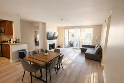 a living room with a table and chairs and a kitchen at Marina Breeze Retreat 2BR 2BA - Close To Venice Beach in Los Angeles