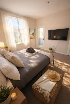 a room with two beds and a couch and a flat screen tv at Coastal Modern in MDR in Los Angeles