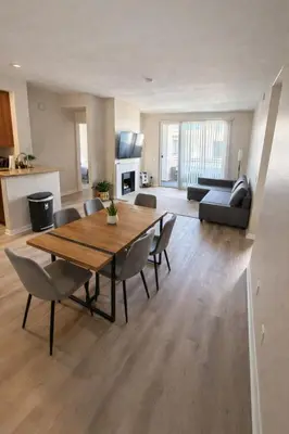 a living room with a wooden table and chairs at Marina del Rey Comfort - Venice Beach Vibes - 2BR & 2BA in Los Angeles
