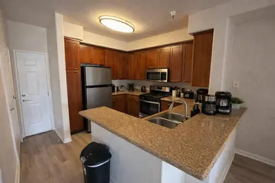 a kitchen with wooden cabinets and a granite counter top at Marina del Rey 2BR-2BA Oasis Near Venice Beach Boardwalk in Los Angeles
