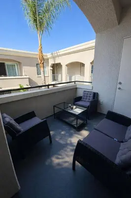 a balcony with two couches and a palm tree at Marina del Rey Prime 2BR-2BA Location Near Venice Beach in Los Angeles