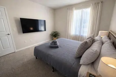 a bedroom with a large bed and a flat screen tv at Marina del Rey Prime 2BR-2BA Location Near Venice Beach in Los Angeles