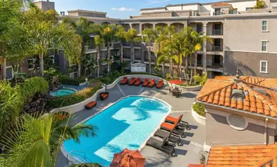 an overhead view of the pool at a resort with palm trees at Marina del Rey 2BR-2BA Coastal Retreat Near Venice Beach in Los Angeles