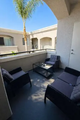 a balcony with two couches and a palm tree at Marina del Rey Prime Location & Venice in Los Angeles