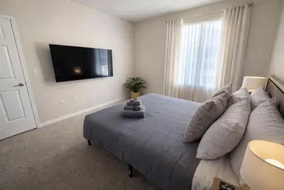 a bedroom with a large bed and a flat screen tv at Marina del Rey Prime Location & Venice in Los Angeles