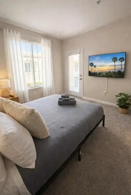 a bedroom with a large bed and two windows at Marina del Rey Prime Location & Venice in Los Angeles