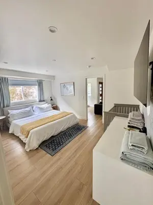 a white bedroom with a bed and a desk at Modern 3Bedroom 3Bath Townhouse in Sherman Oaks