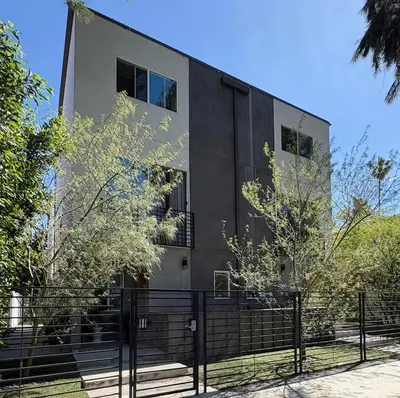 a black building with a fence in front of it at Modern 3Bedroom 3Bath Townhouse in Sherman Oaks