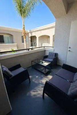 a balcony with couches and a table and a palm tree at Marina del Rey 2BR-2BA Near Venice Boardwalk in Los Angeles