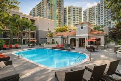 a swimming pool with chairs and tables and buildings at Marina del Rey 1BR -- Near Venice Beach in Los Angeles