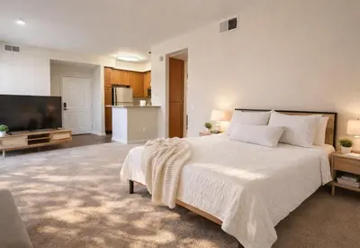 a bedroom with a large bed and a kitchen at SereneStays Marina Del Rey Getaway - Right By The Marina in Los Angeles