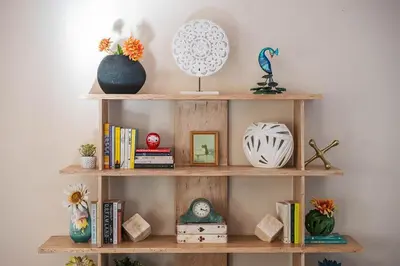 a wooden shelf with books and vases on it at Beautiful Monterey Park Home With a View, Backyard and BBQ in Monterey Park
