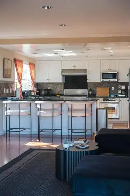 a kitchen with an island in a living room at Beautiful Monterey Park Home With a View, Backyard and BBQ in Monterey Park