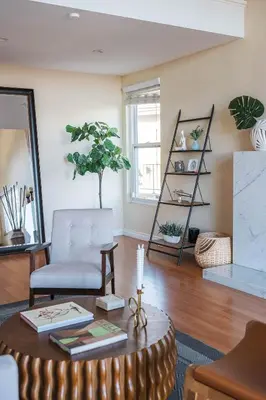 a living room with a chair and a table at Beautiful Monterey Park Home With a View, Backyard and BBQ in Monterey Park