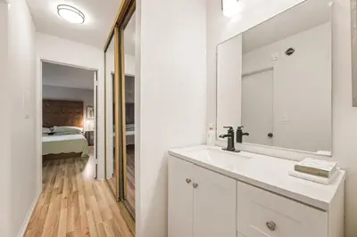 a white bathroom with a sink and a mirror at Elegant Luxe Hampton inspo Retreat in Glendale, CA in Glendale