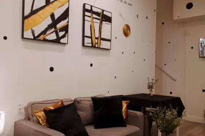 a living room with a couch and a table at Noir and Gold Retreat in Los Angeles