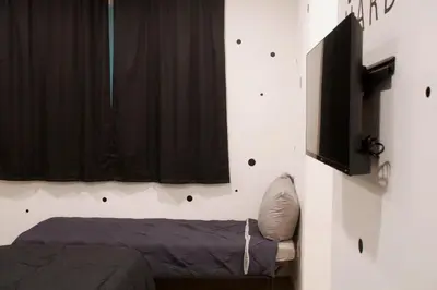 a bedroom with a bed and a window at Noir and Gold Retreat in Los Angeles