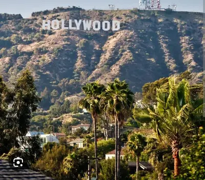 a view of a mountain with a hollywood sign on it at 2Bed Apt View of Hollywood Sign & Rooftop Pool in Los Angeles