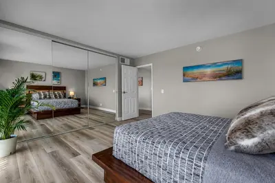 a bedroom with a bed and a glass wall at Marina Chic Apartment! Free Parking in Los Angeles