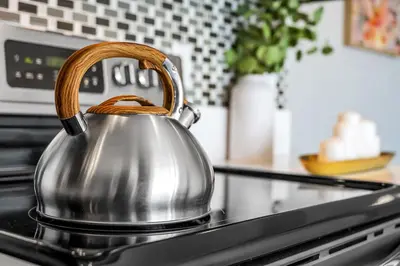 a silver tea kettle with a wooden handle on a stove at Marina Chic Apartment! Free Parking in Los Angeles