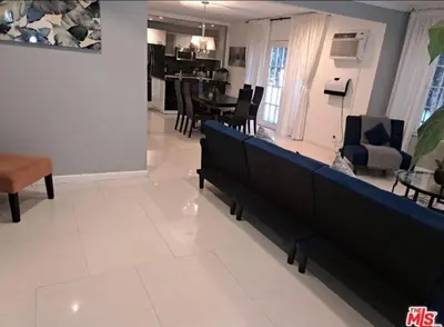 a living room with benches and a dining room at Residents inn in Los Angeles