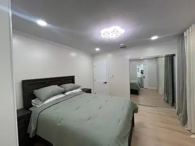 a bedroom with a large bed and a hallway at Modern Family 3BR Near LAX & Disney in Torrance