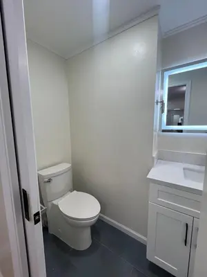 a white bathroom with a toilet and a sink at Modern Family 3BR Near LAX & Disney in Torrance