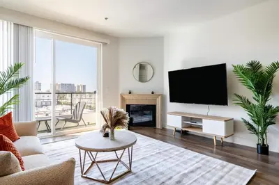a living room with a tv and a fireplace at Sleek Marina Den, Central, Gym, Pool, King Bed in Los Angeles
