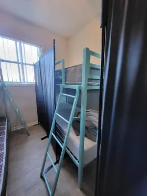 a room with two bunk beds and a refrigerator at Bunk bed spot available, Central LA in Los Angeles