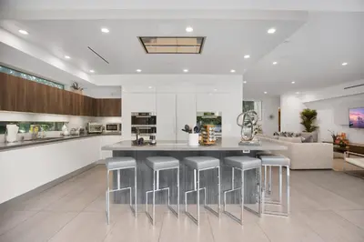 a kitchen with a large island with bar stools at Colgate Vantage in Los Angeles