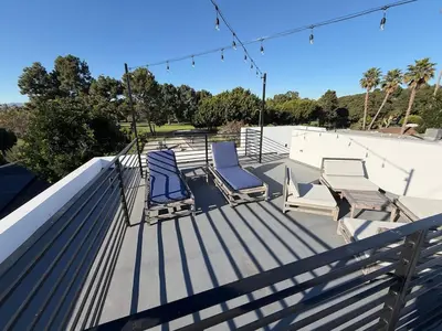 a group of chairs sitting on top of a roof at NEW Venice Rose Ave Retreat with Sunset Deck in Los Angeles