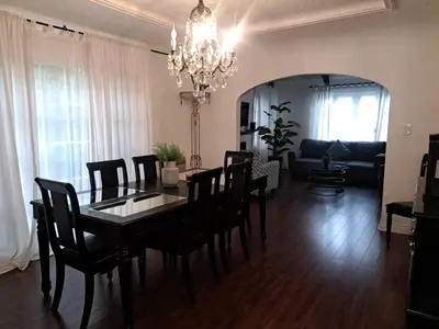 a dining room with a table and chairs and a living room at 3 bedroom plus 2 baths in Beverly hills in Los Angeles