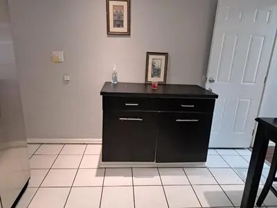 a black cabinet in a room with a white tile floor at 3 bedroom plus 2 baths in Beverly hills in Los Angeles