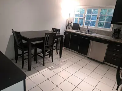 a kitchen with a table and chairs and a sink at 3 bedroom plus 2 baths in Beverly hills in Los Angeles