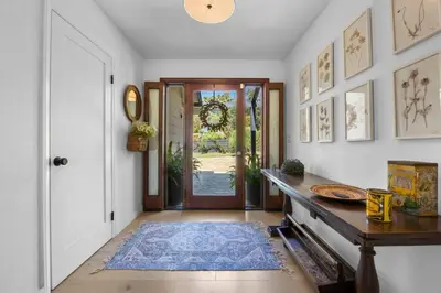a hallway with a door and a table with a rug at Luxury Ojai Escape Pool, Jacuzzi & Tennis Court in Ojai