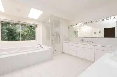 a white bathroom with a tub and a sink at Sunset villa in Los Angeles