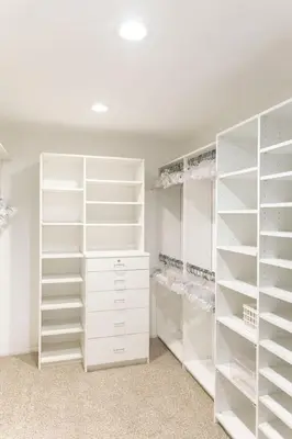 a white walk in closet with white shelves at Sunset villa in Los Angeles