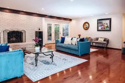 a living room with blue furniture and a fireplace at Sunset villa in Los Angeles