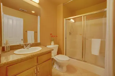 a bathroom with a toilet and a sink and a shower at Resort-Style Oasis Expansive Riverside Mansion in Riverside