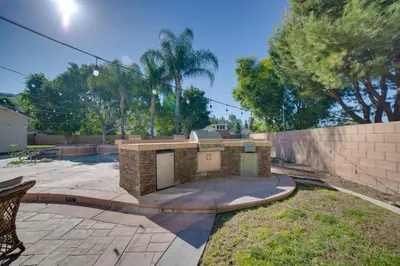 a backyard with a brick fireplace in a yard at Resort-Style Oasis Expansive Riverside Mansion in Riverside