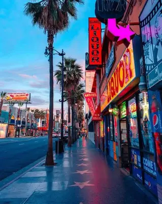 a city street with many neon signs and palm trees at Penthouse Escape Pool Views in Glendale