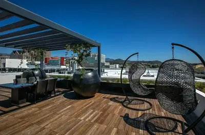 a patio with two metal chairs on a deck at Penthouse Escape Pool Views in Glendale