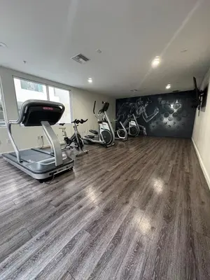 a gym with treadmill and exercise bikes in a room at Penthouse Escape Pool Views in Glendale