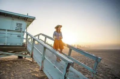 a woman standing on a pier on the beach at Drift & Dream - Opulent 1BR Marina Escape in Los Angeles